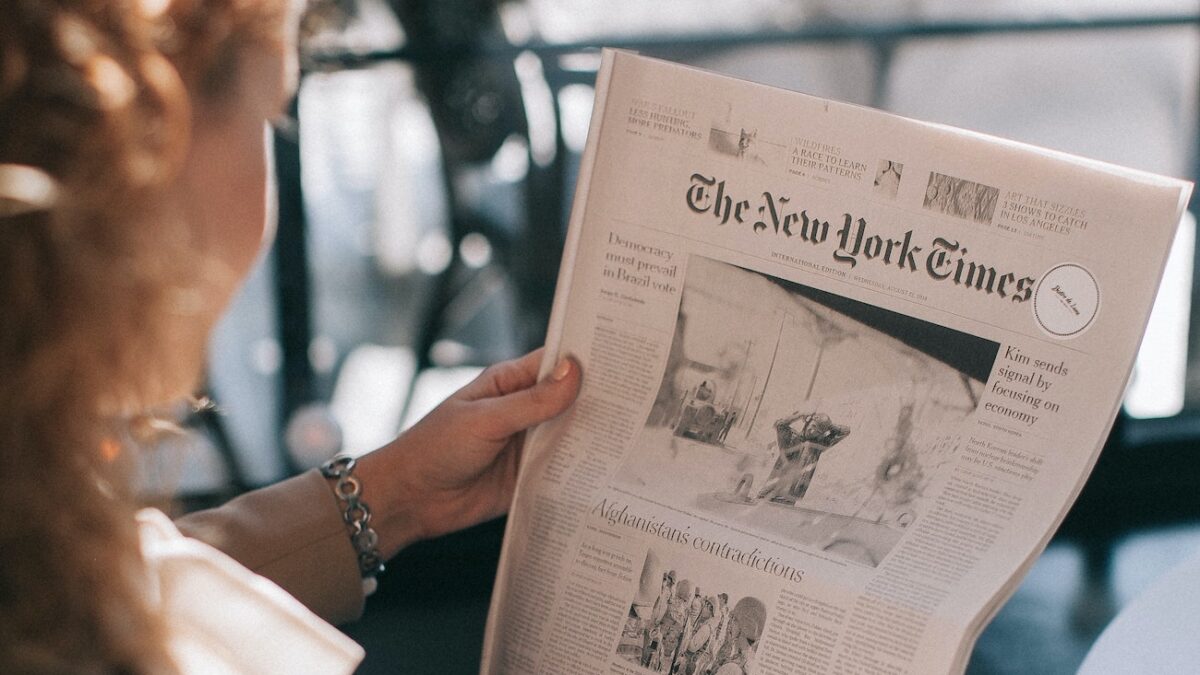 woman reading the New York Times paper