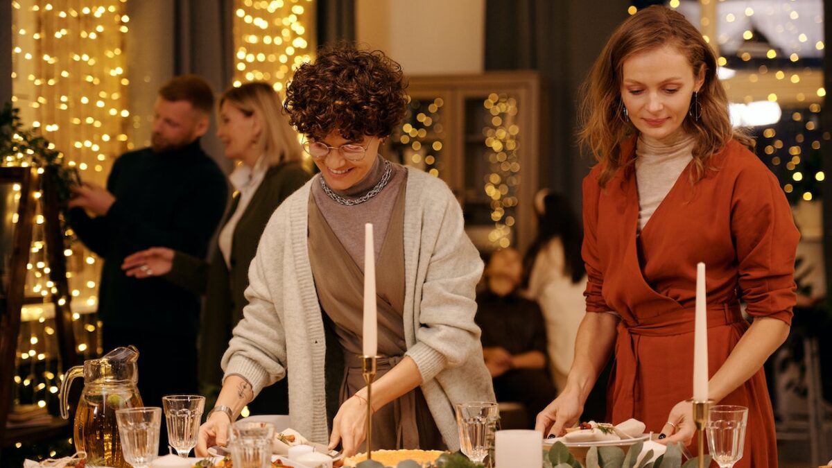 two women in holiday buffet line getting food