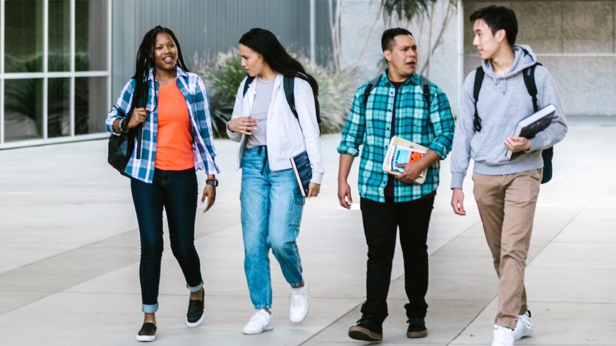 four college students walking together