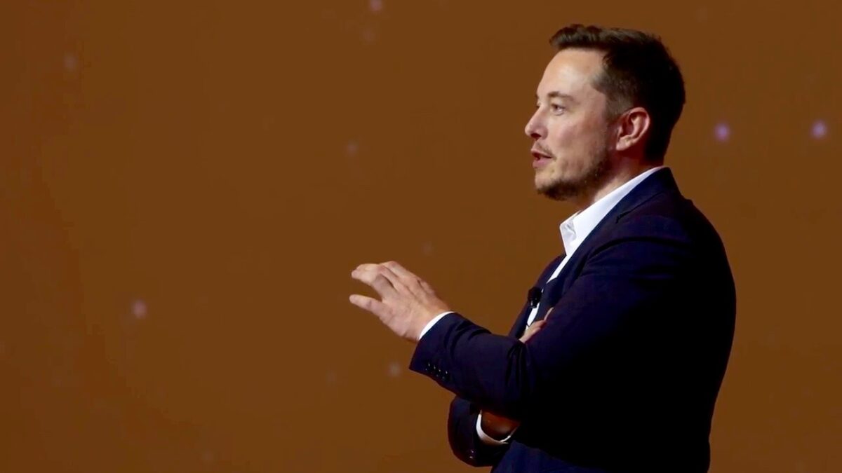 Elon Musk giving presentation on stage