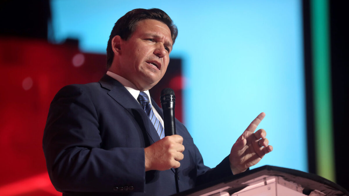 Ron DeSantis speaking into a mic onstage
