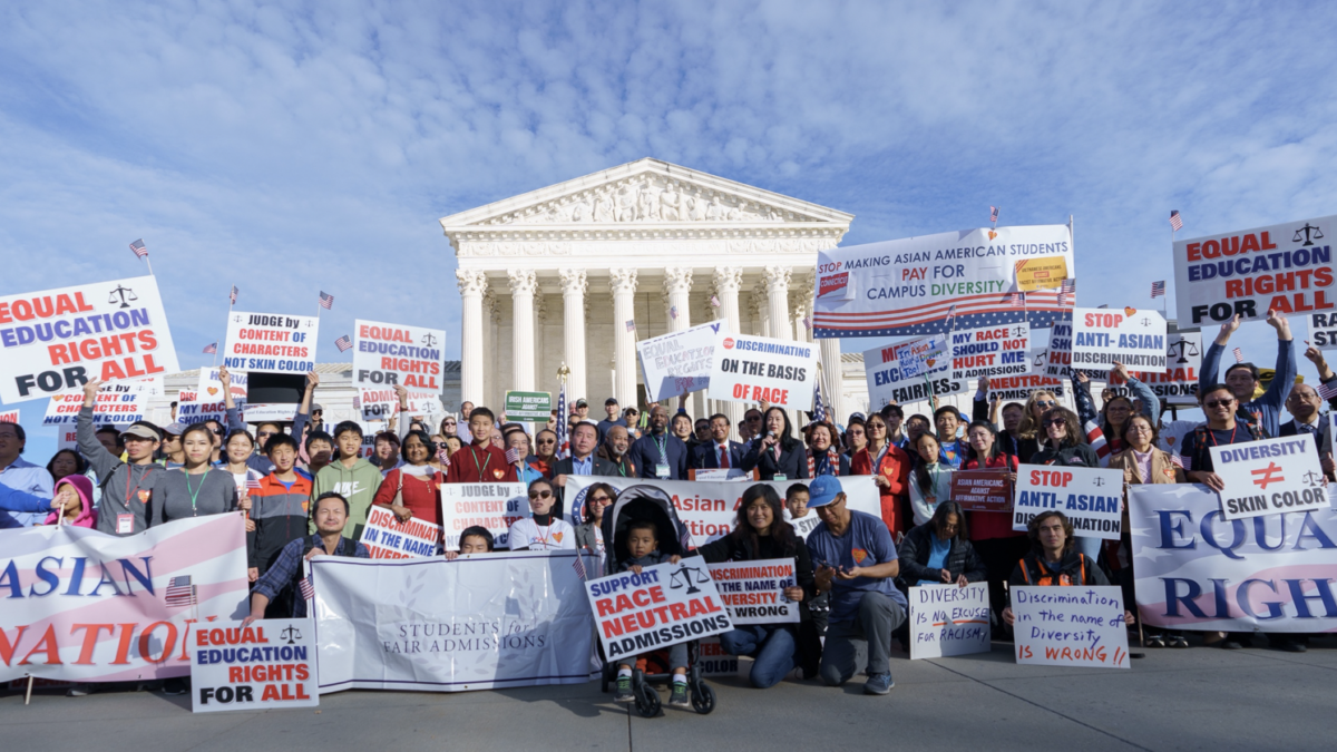 parents and students pose at rally outside of supreme court