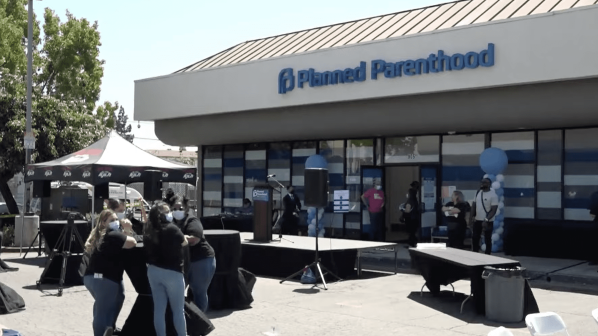 women setting up table outside of a Planned Parenthood building