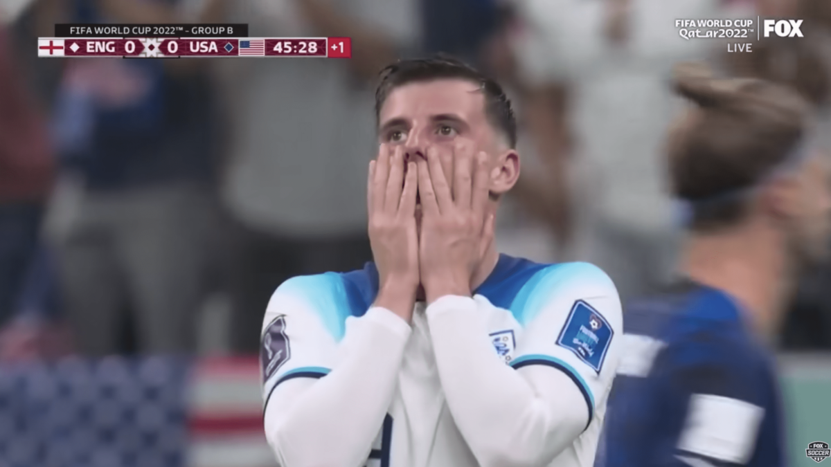 Soccer player holds hands up to his face in nervousness
