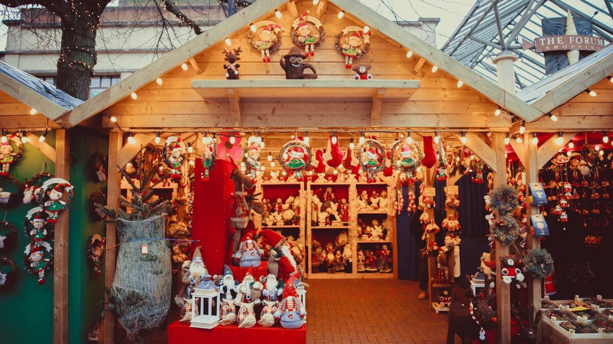 shelves of plush christmas toys and decor in small holiday market