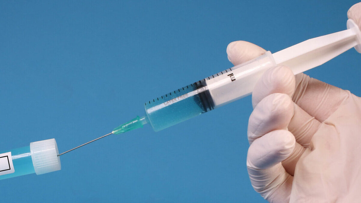 Covid vaccine doctor holding syringe