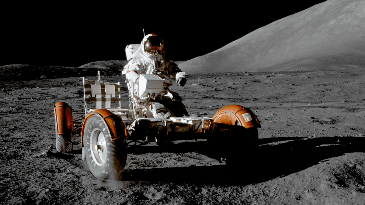 astronaut rides lunar rover on moon surface
