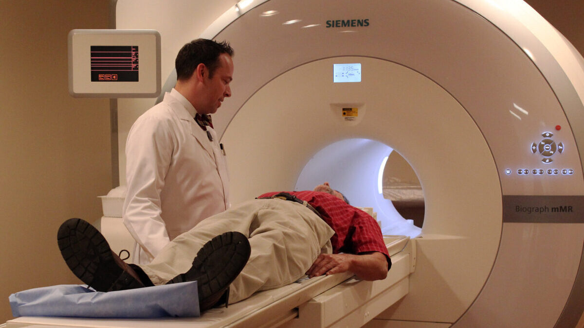 Doctor putting a man into an MRI