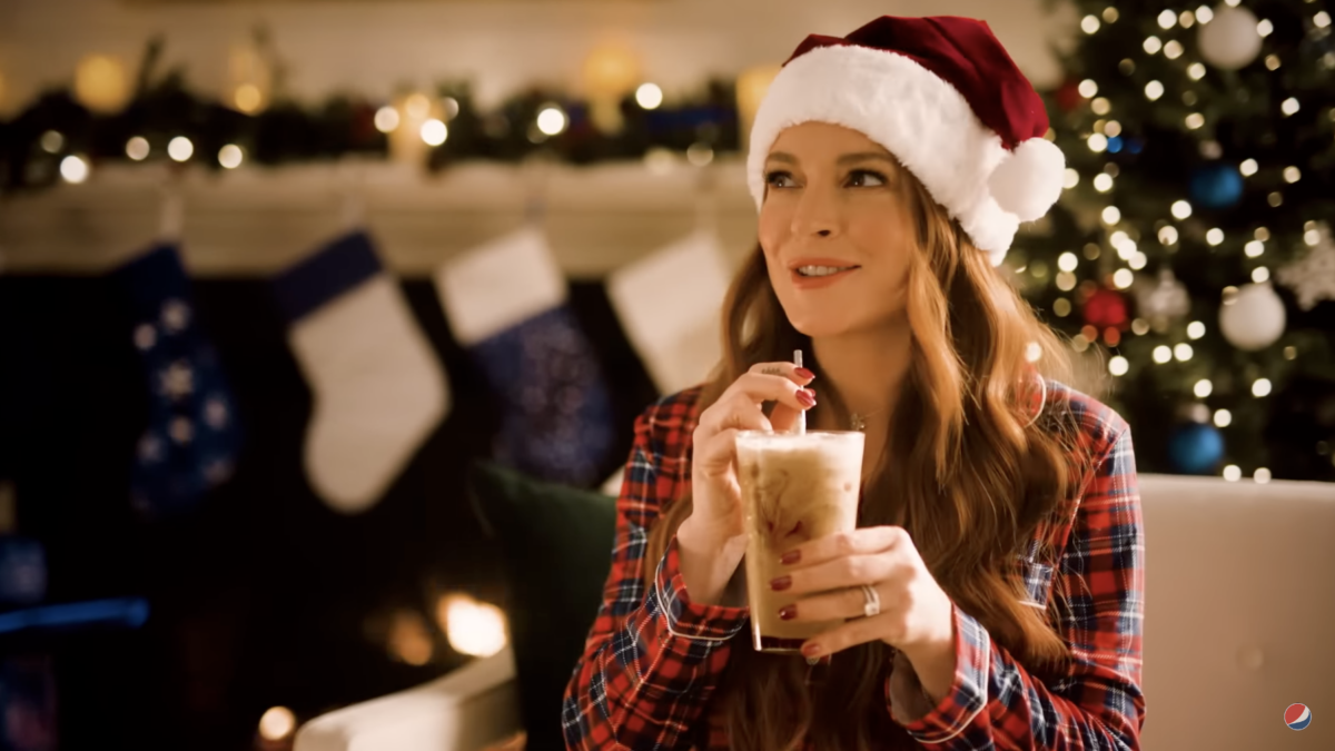 Lindsay Lohan in santa hat drinking Pepsi and milk in a glass