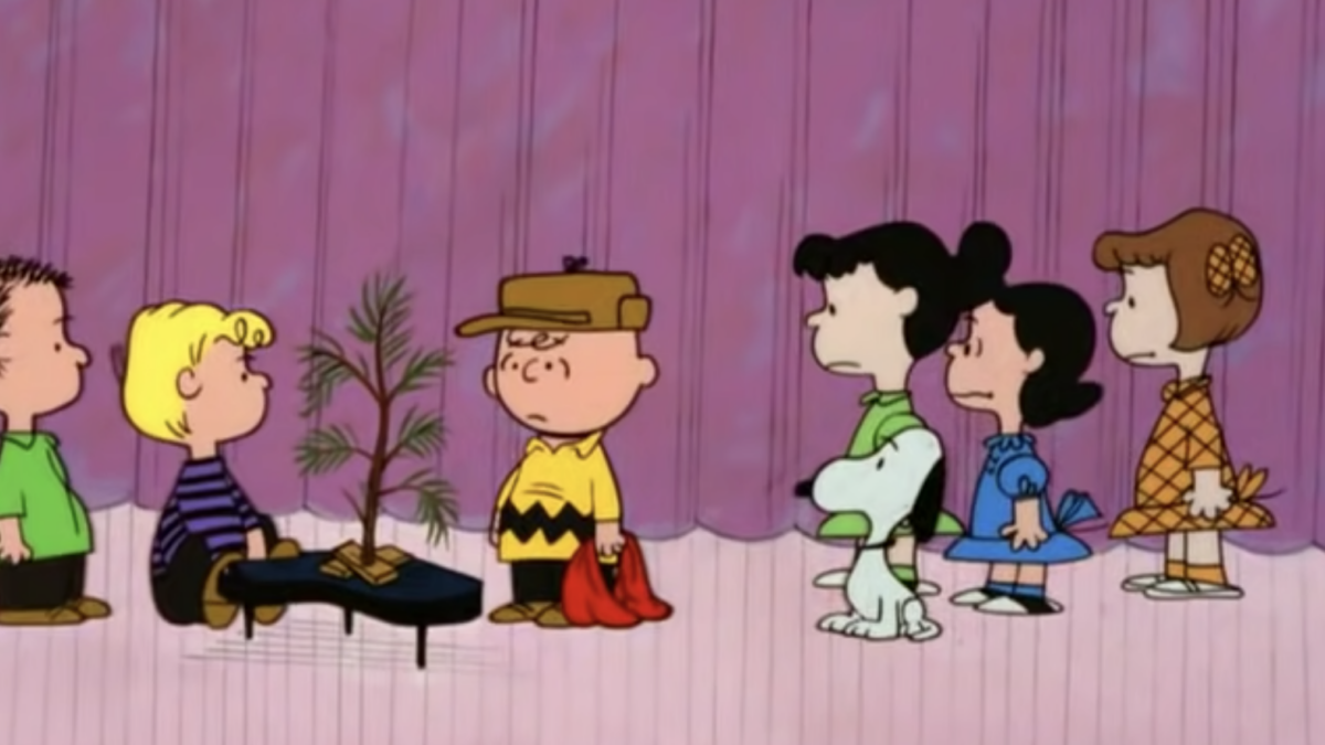 animated scene of charlie brown and friends around piano