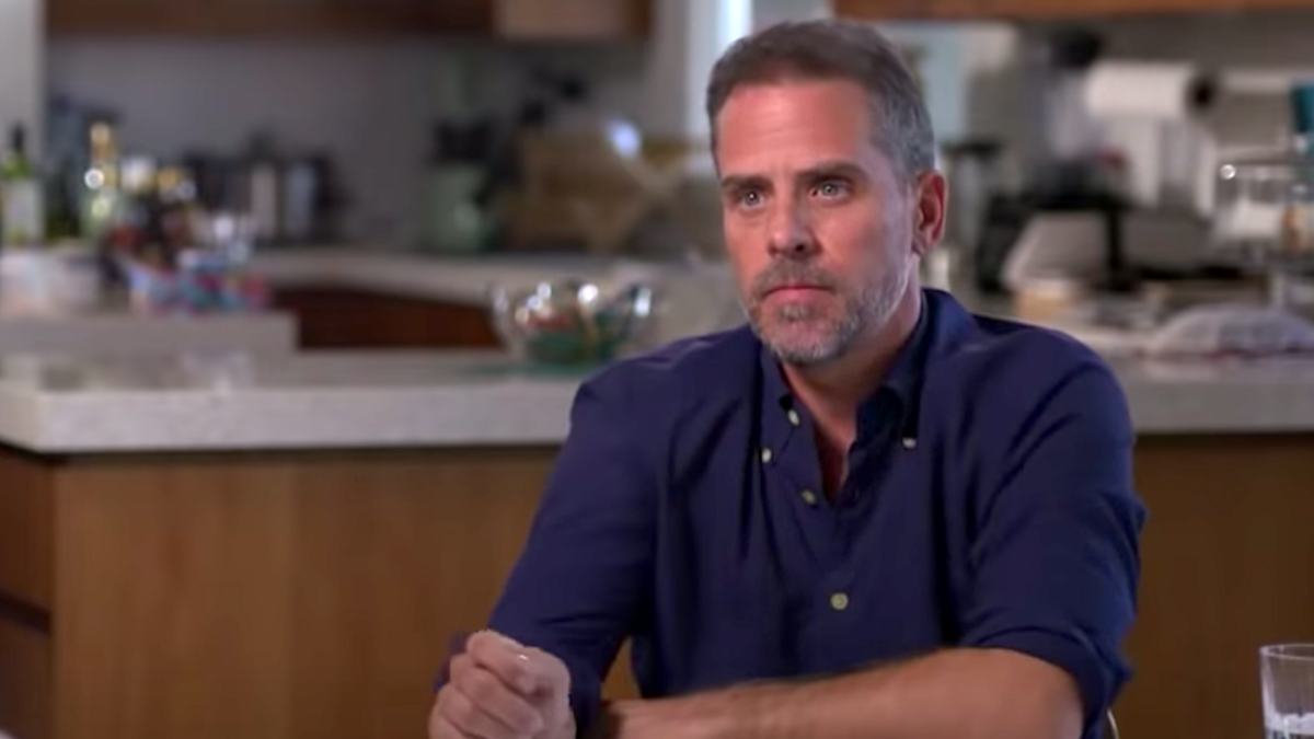 Hunter Biden in blue shirt sitting at a table for ABC News interview