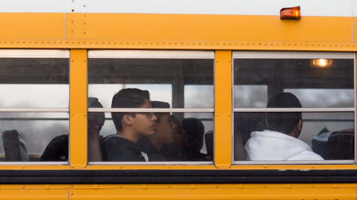 close up of a school bus window with children inside