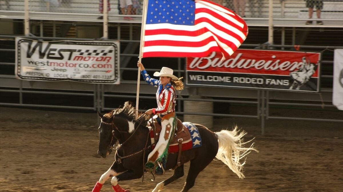 Person on horseback waving American flag