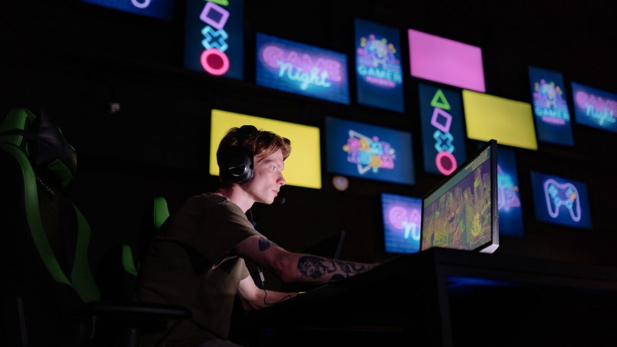 An article on the job crisis has a picture of a young man playing video games on a computer.