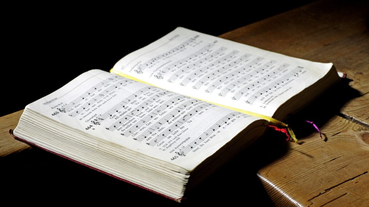 hymnal book with sheet music lies open on table