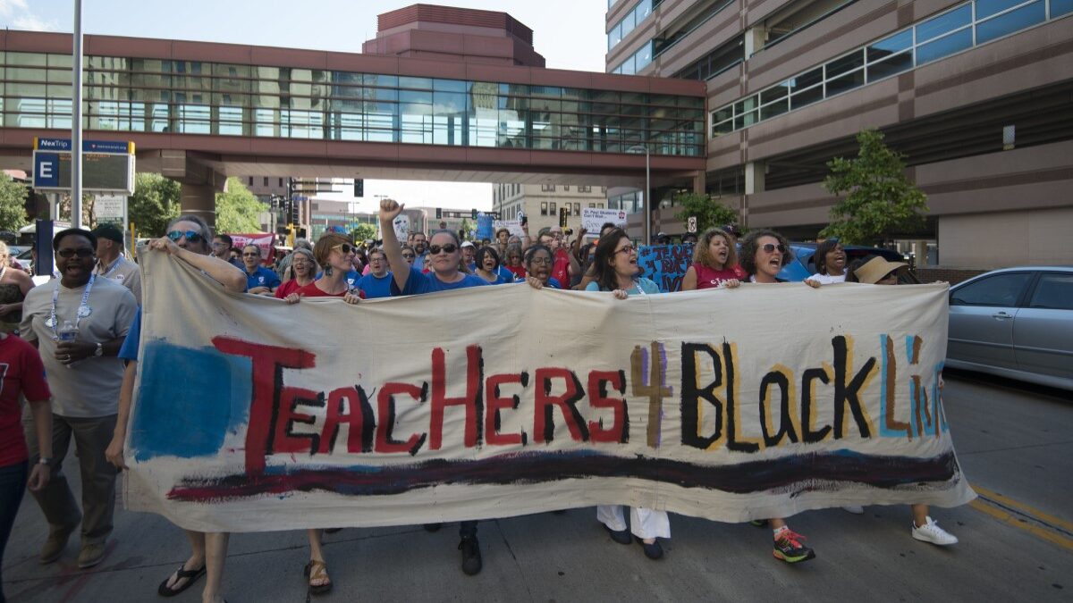 Minnesota teachers protesting with banner