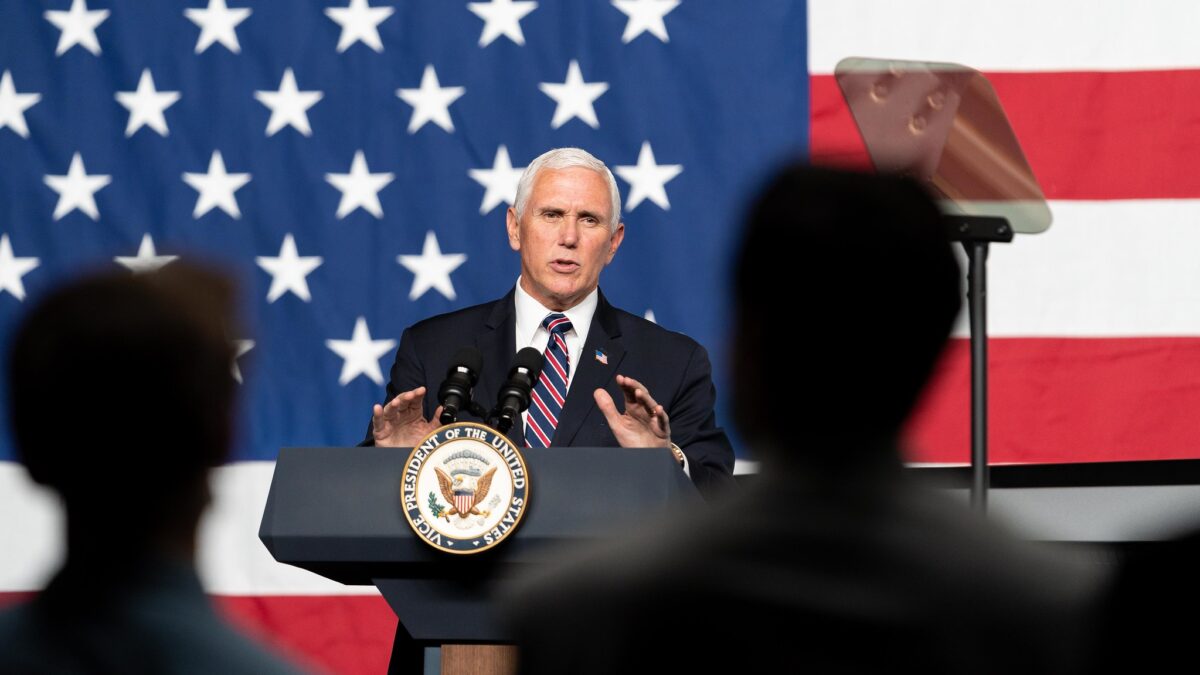 Mike Pence speaking in front of American flag backdrop