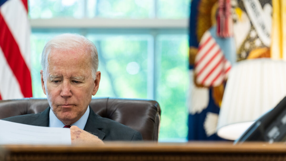 Joe Biden reading classified document at his desk