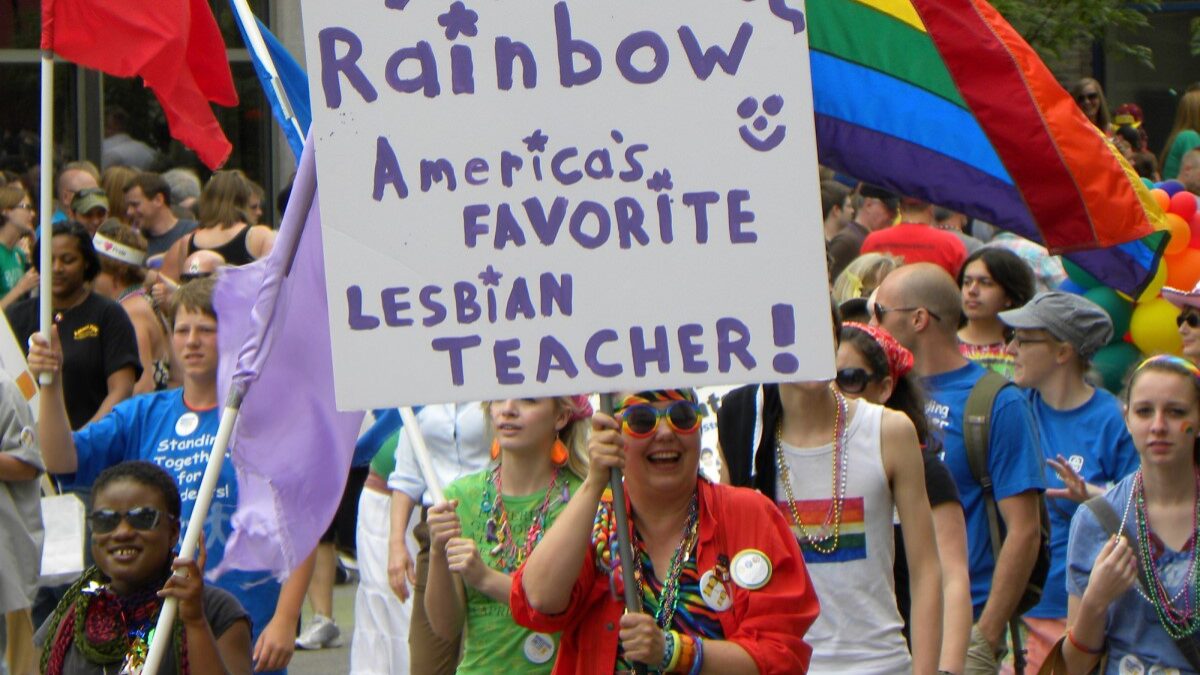 Minnesota teacher with a lesbian sign