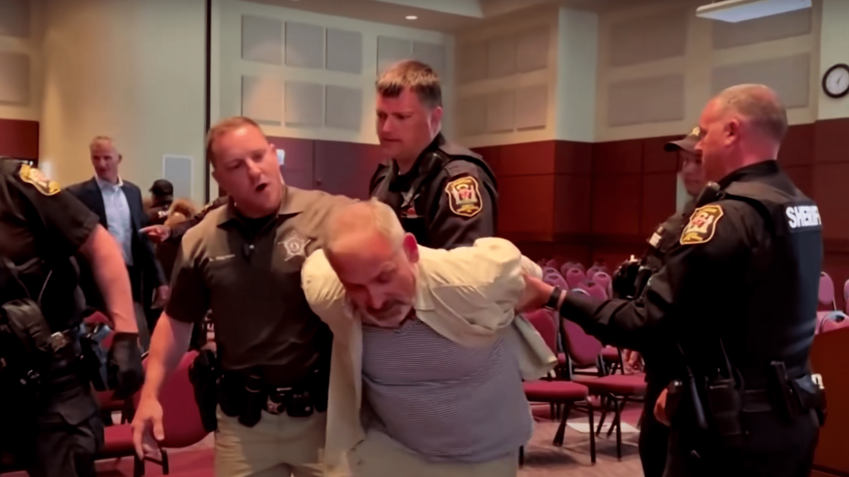 John Tigges being arrested at school board meeting