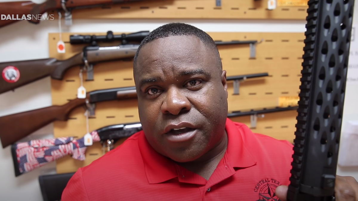 Michael Cargill holding a gun with a bump stock in his store