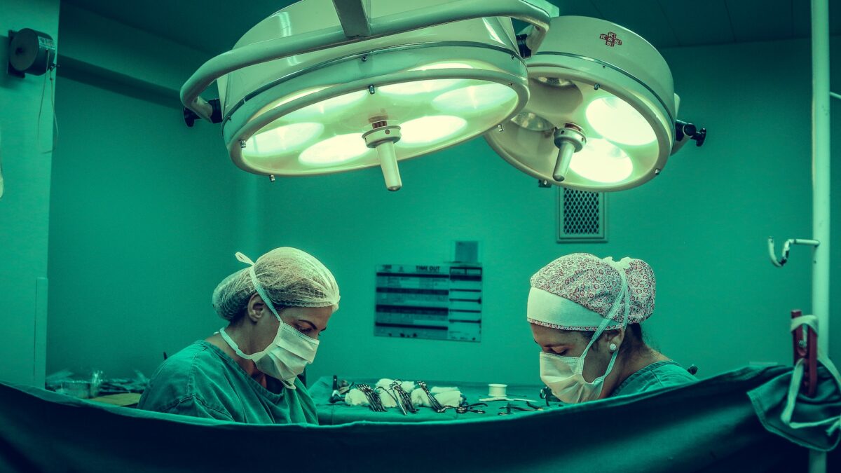 Doctors performing Surgery under lights in OR