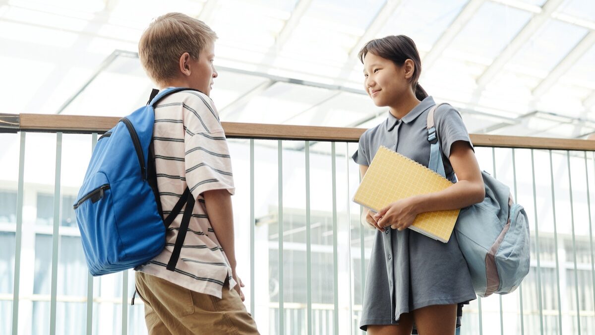 Asian girl student talking to boy student