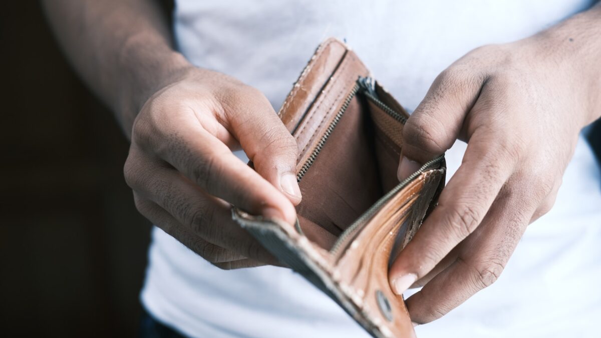 close-up of man holding an empty wallet