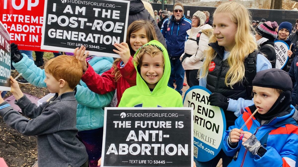 child holds anti-abortion sign at Virginia march for life