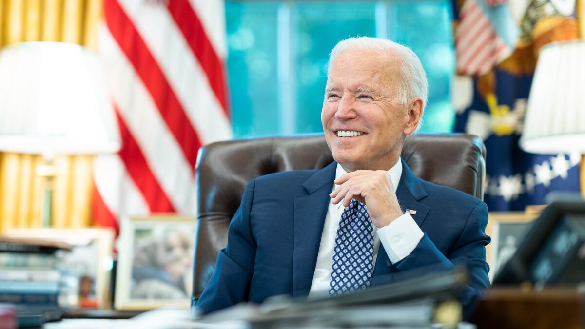 Joe Biden smiling at his desk