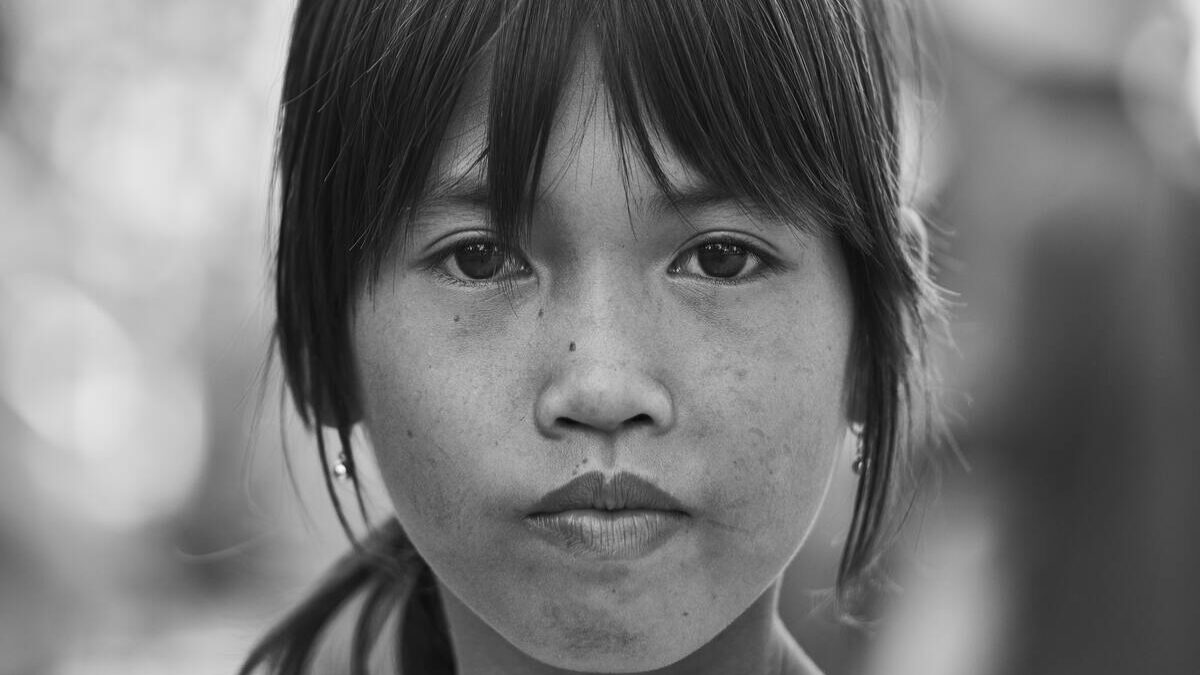 Young girl staring at camera in black and white