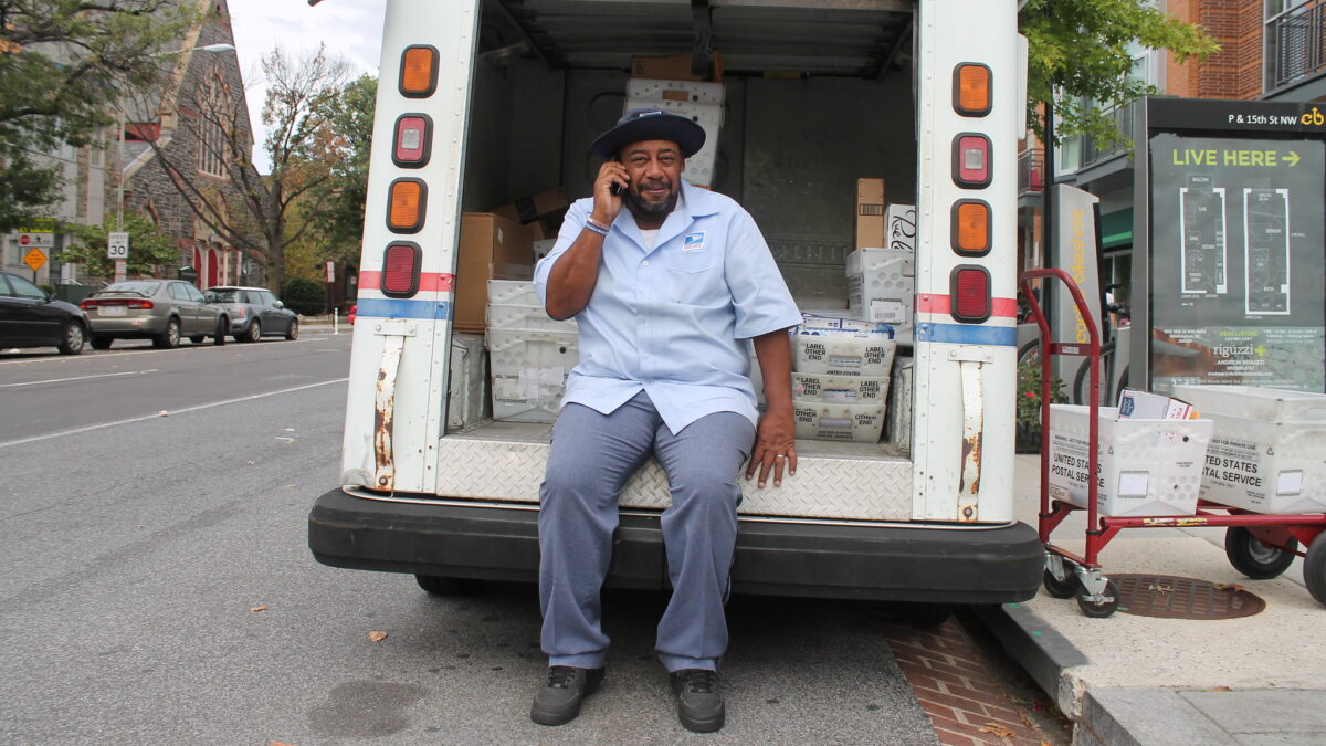 USPS man sitting in the back of his mail truck