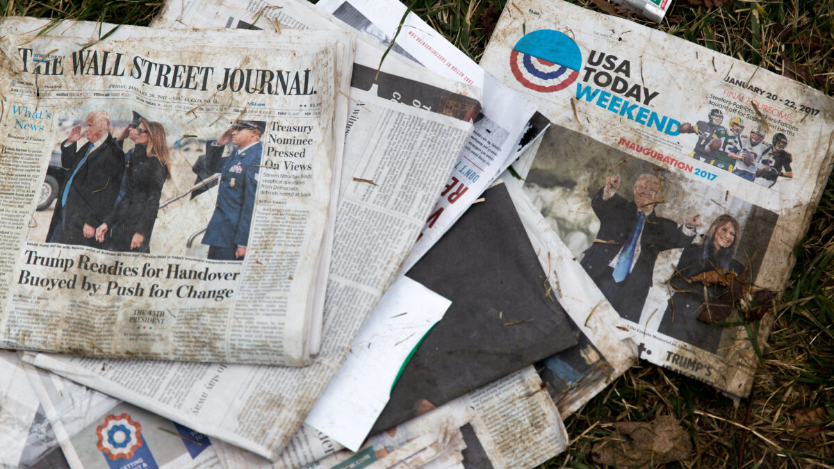dirty newspapers on the grass