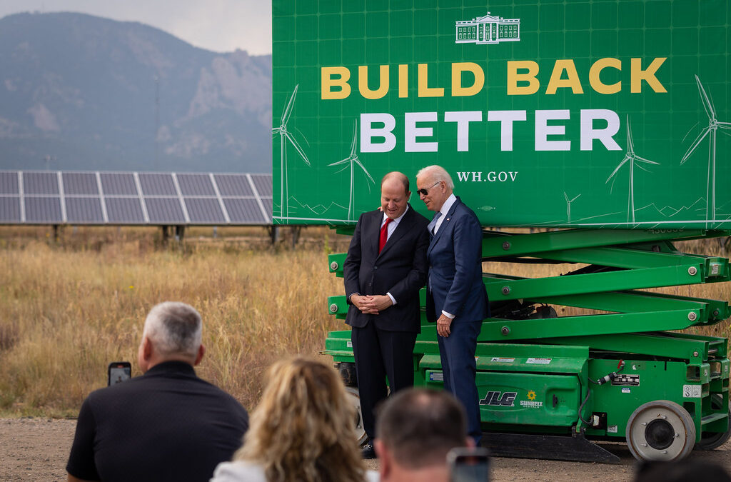 President Joe Biden confers with Gov. Jared Polis before delivering remarks on Build Back Better,