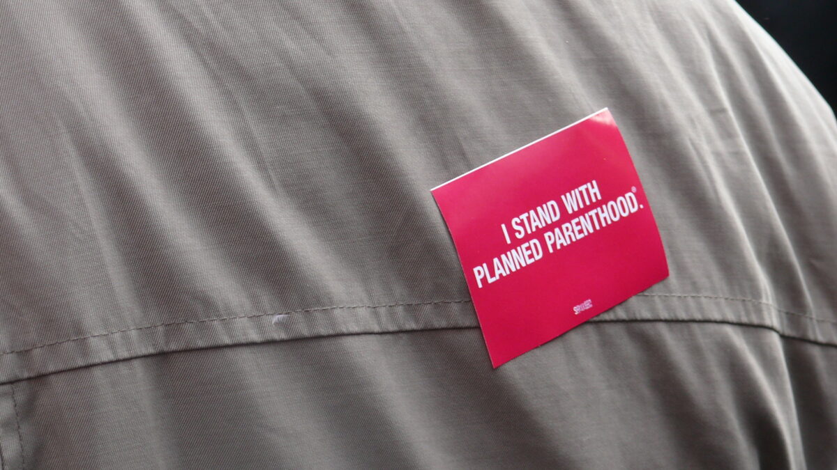 "I stand with Planned Parenthood" sticker on someone's back