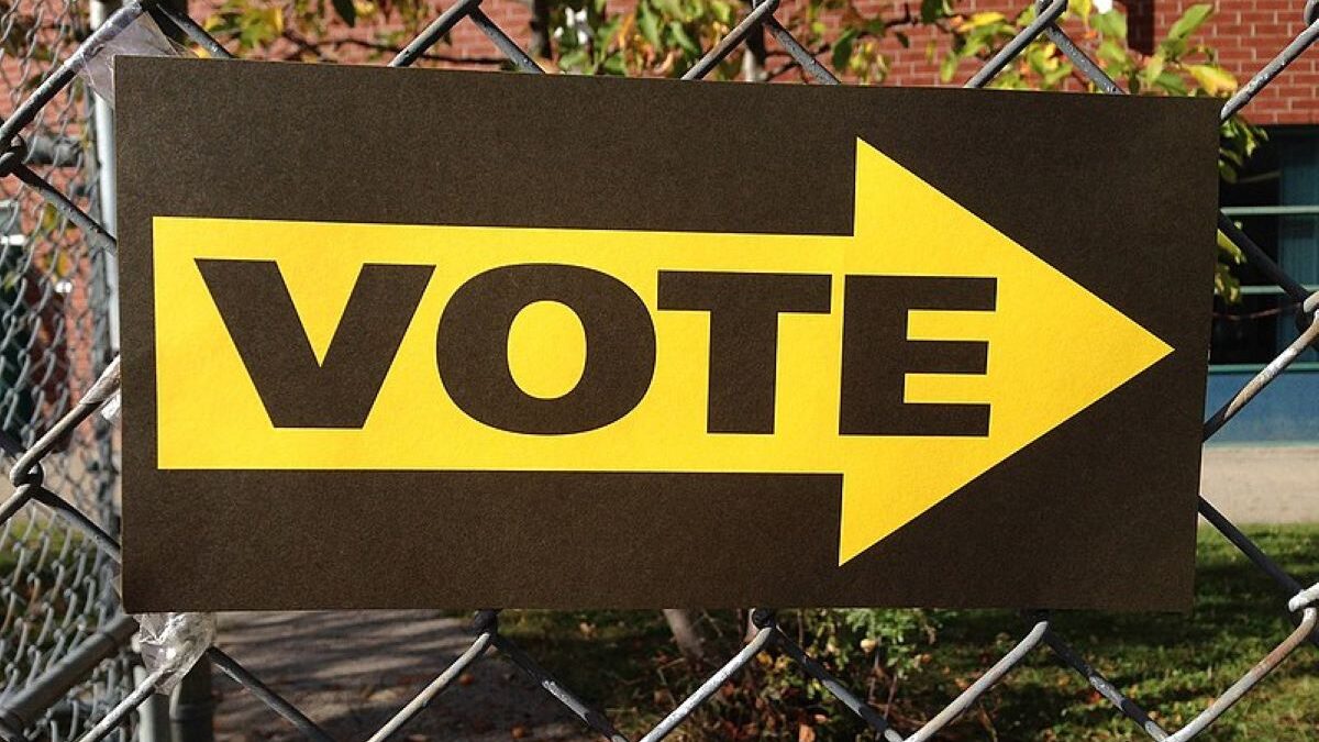 A 'vote' sign attached a fence