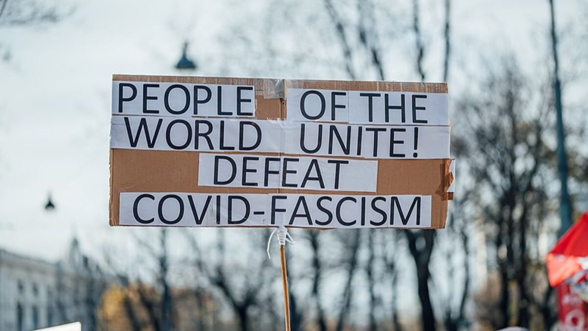 A sign at a protest against Covid fascism, calling for a Covid reckoning