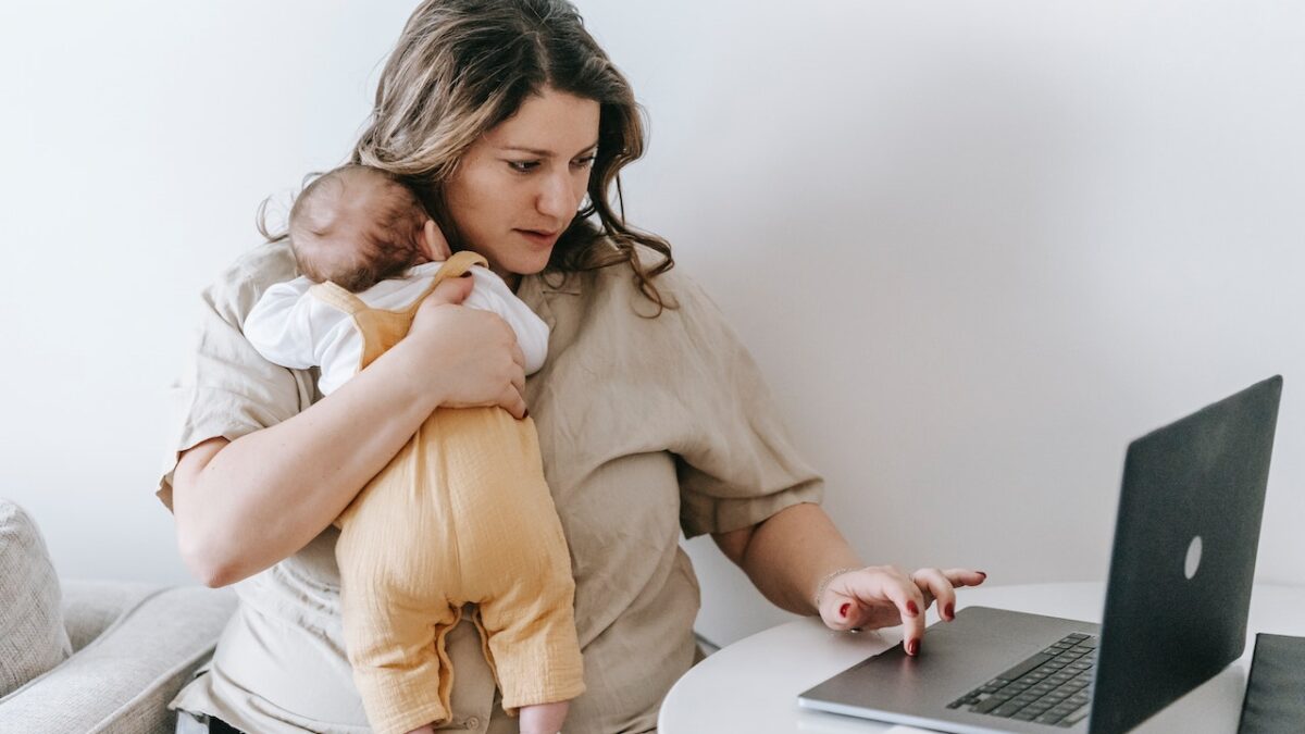 Woman working from home with baby