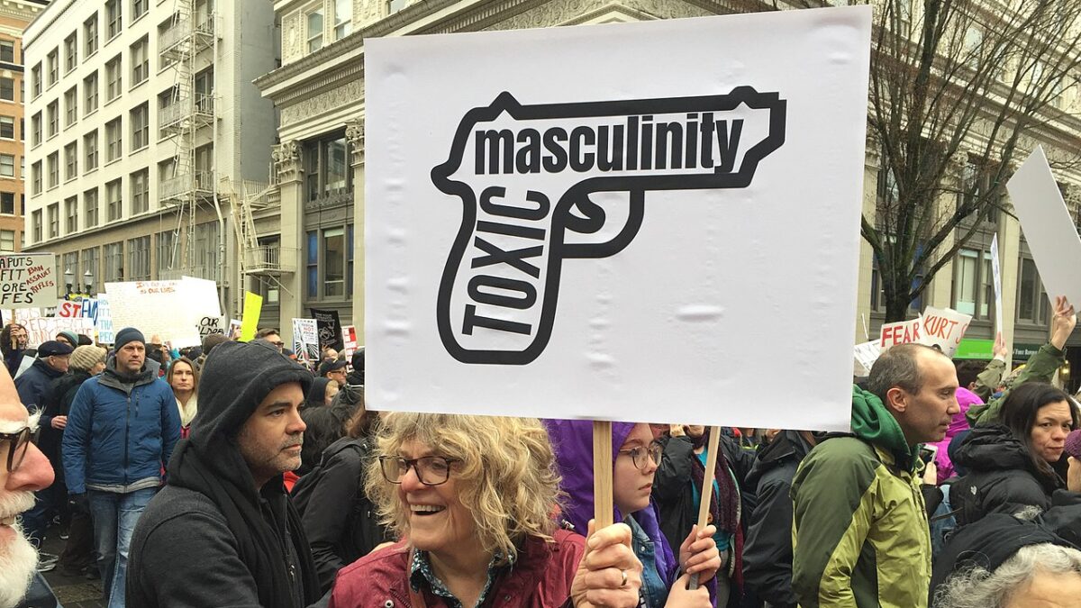 woman holding toxic masculinity sign at gun protest