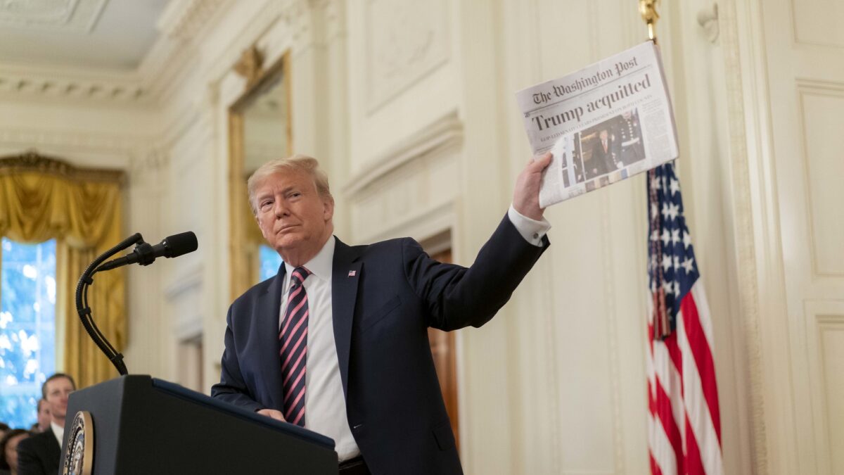 Trump holds up "acquitted" news article