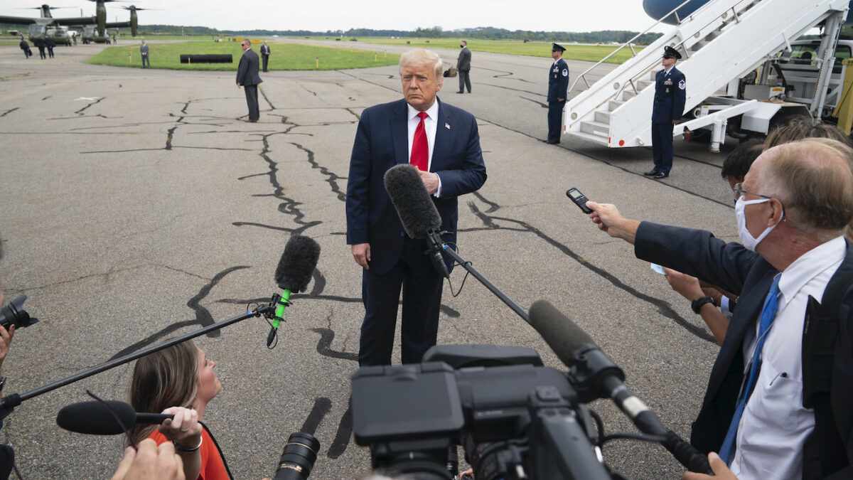 Trump talks to the press on the tarmac