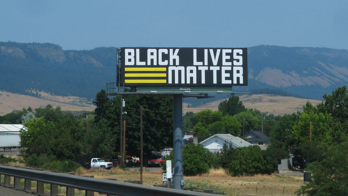 billboard reading "Black Lives Matter" with mountains in background