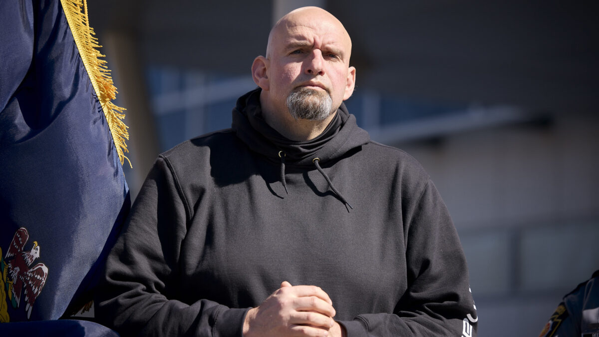 A picture of John Fetterman shows him standing with his hands clasped.