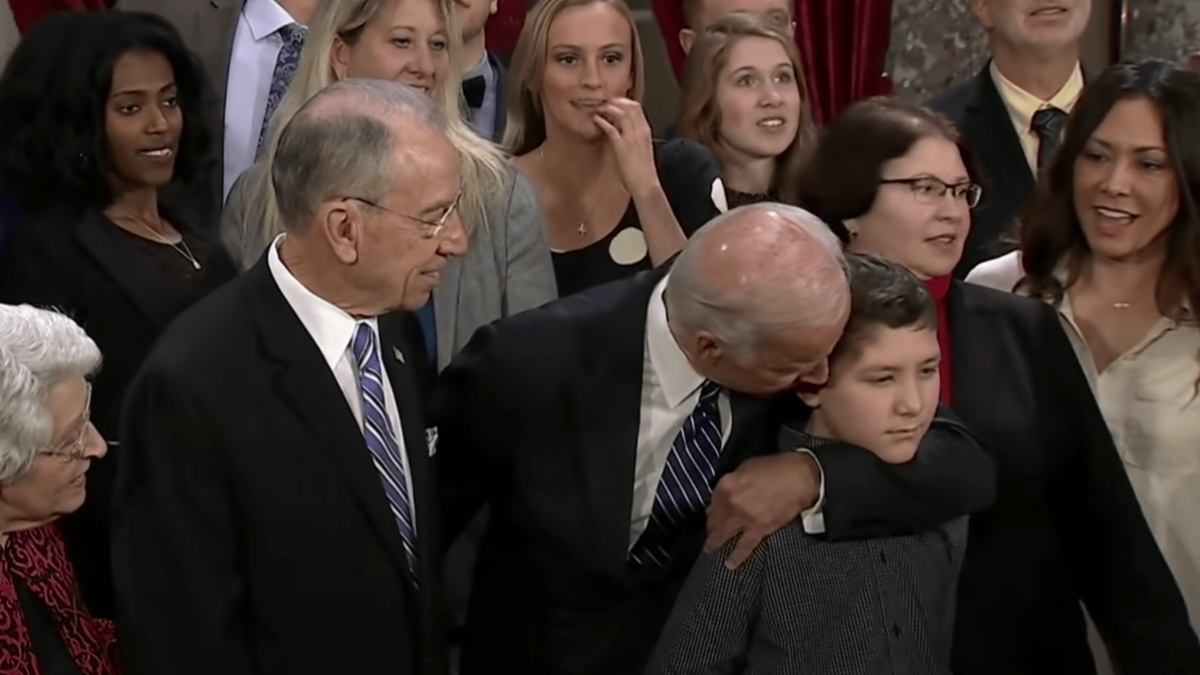Joe Biden sniffs child’s head during photo op