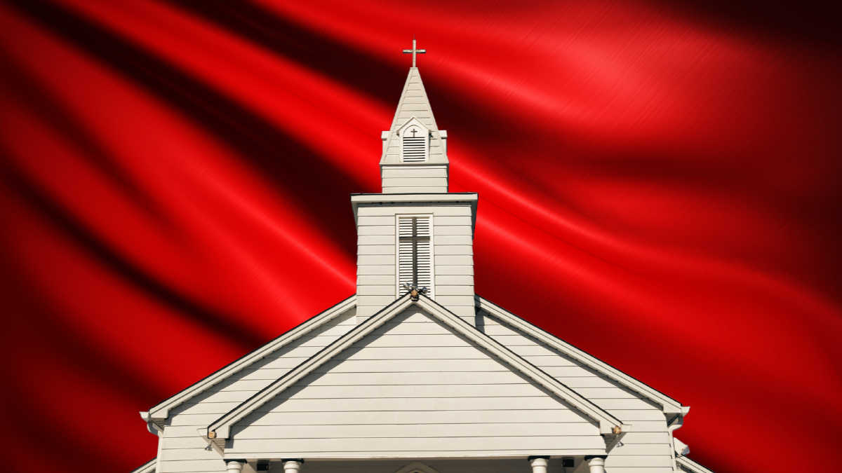 red flag behind white Church