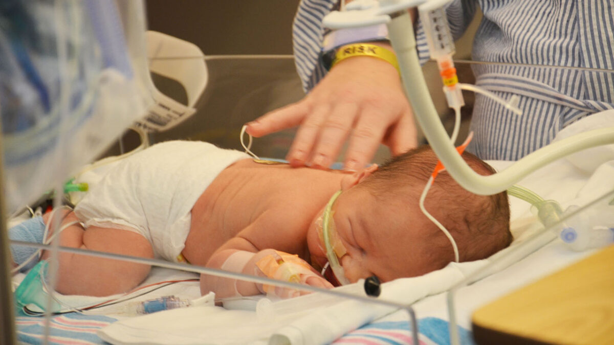 newborn baby laying in hospital