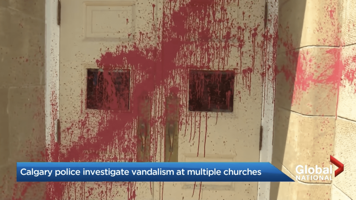 news report showing red paint thrown on church doors