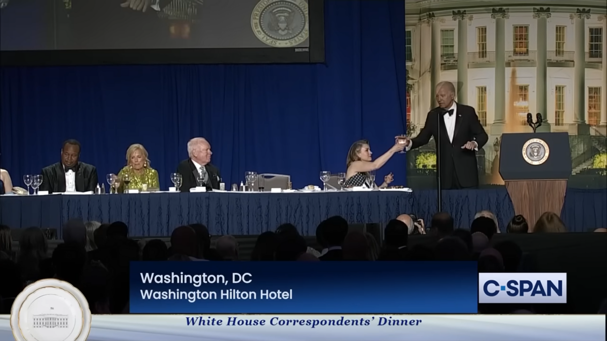 Biden is handed champagne glass by reporter