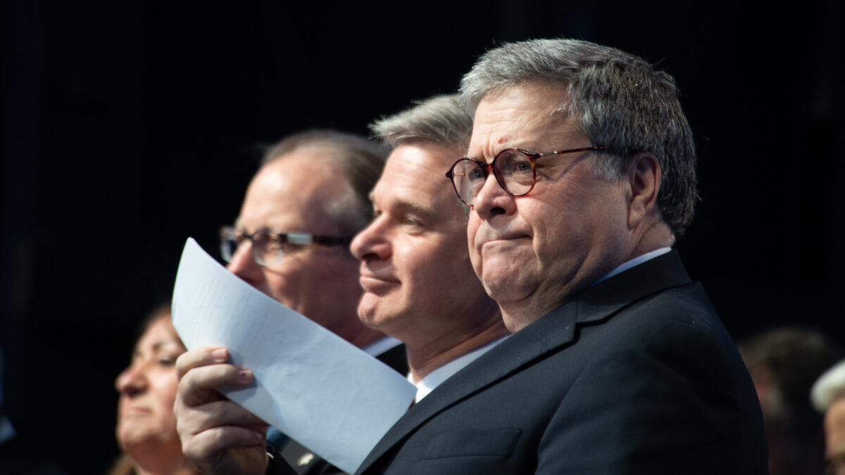 William Barr with Christopher Wray in the background