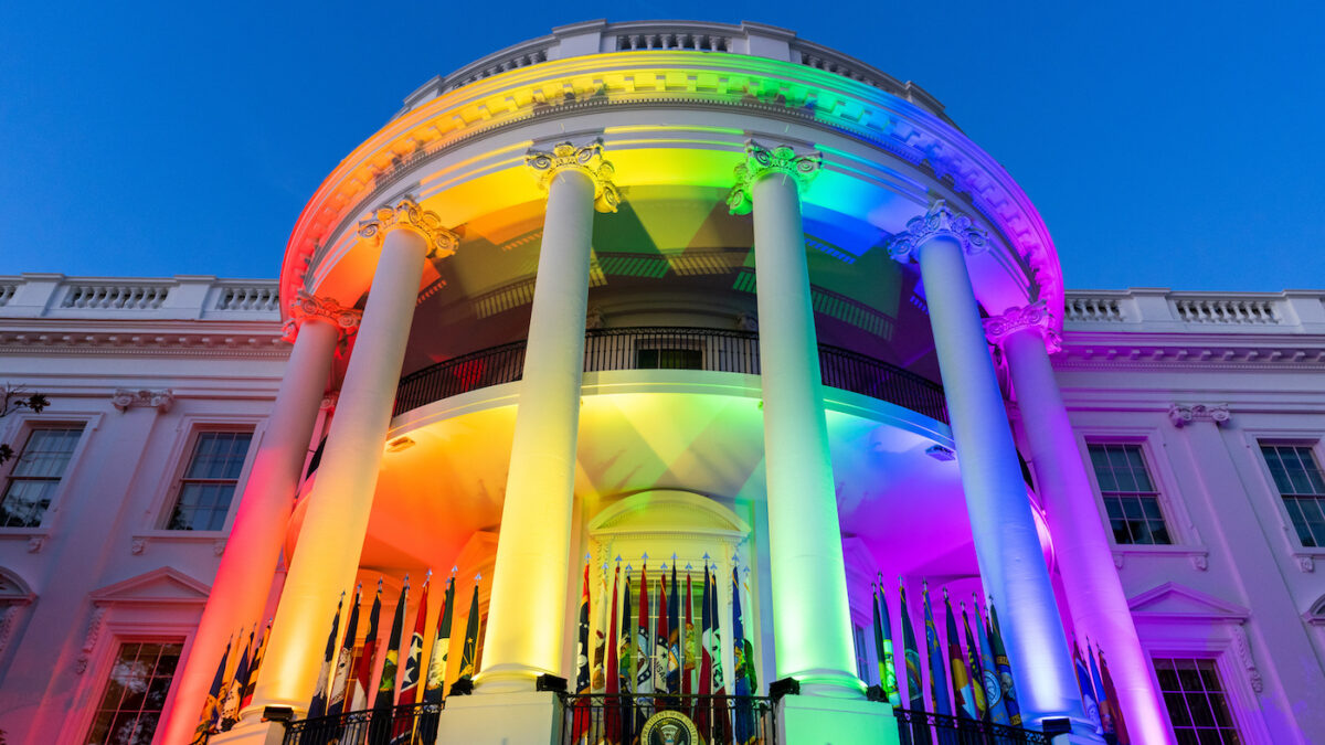 white house lit up with rainbow pride flag colors